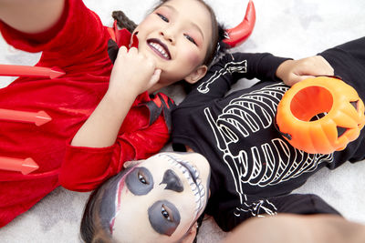 High angle view of happy woman lying down toy