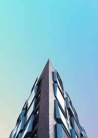 Low angle view of skyscraper against clear blue sky