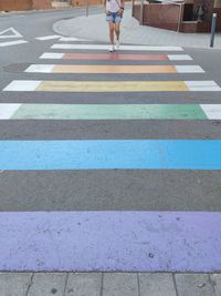 Low section of person crossing road