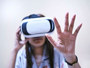 Woman gesturing while using virtual reality simulator