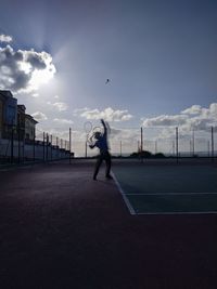 Man playing with ball against sky