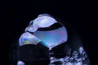 Close-up of bubbles in glass against black background