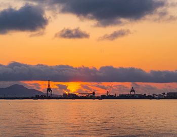 Silhouette of harbor during sunset