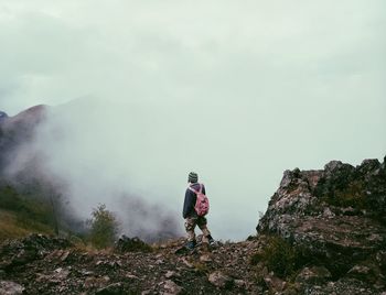 Rear view of man standing on mountain