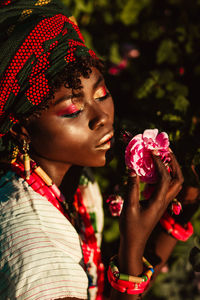 Close-up of woman with pink flowers