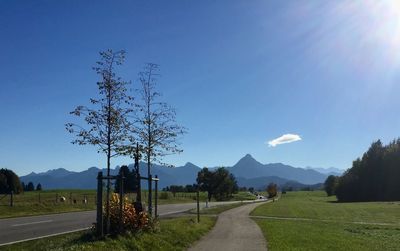 Road amidst field against sky