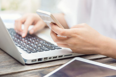 Midsection of man using mobile phone