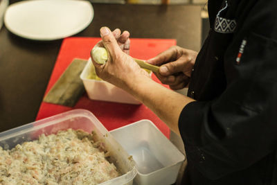 Midsection of man preparing food on table