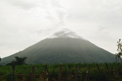 Scenic view of mountains against cloudy sky