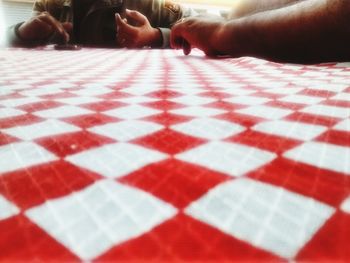 Close-up of woman sitting on tiled floor