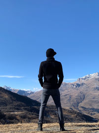 Rear view of man standing on mountain