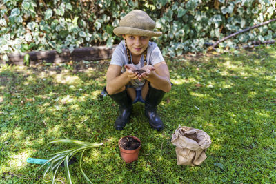 Full length of boy sitting on grass