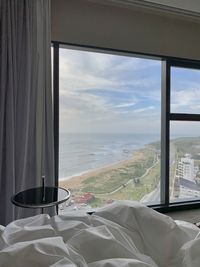 Scenic view of sea seen through glass window