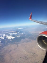 Aerial view of airplane wing against sky