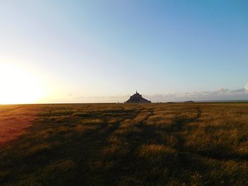 Scenic view of field against clear sky