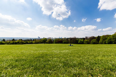 Scenic view of golf course against sky