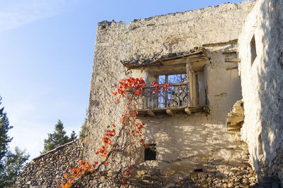 Low angle view of old building against blue sky