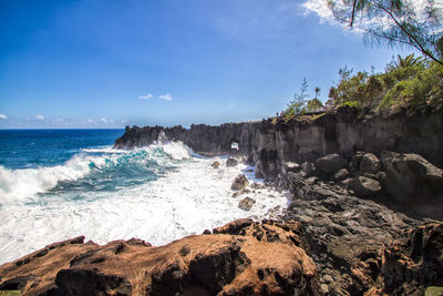 Scenic view of beach against blue sky