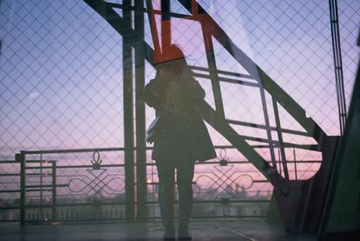 Rear view of woman walking at airport