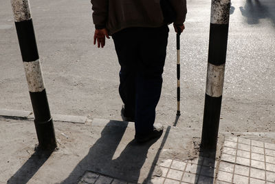 Low section of men standing on street