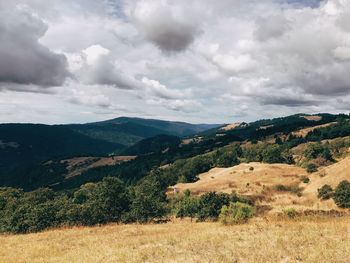 Scenic view of mountains against cloudy sky