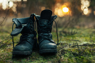 Close-up of shoes on field