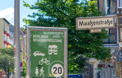 Information sign against trees in city