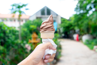 Cropped hand holding ice cream cone