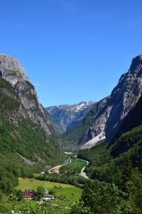 Scenic view of mountains against clear blue sky