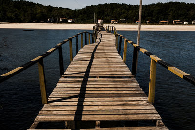 Wooden jetty leading to pier over lake