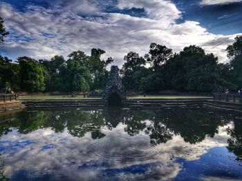 Statue by trees against sky