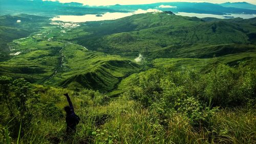 Scenic view of green landscape against sky