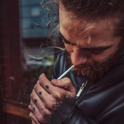 Close-up portrait of man holding camera