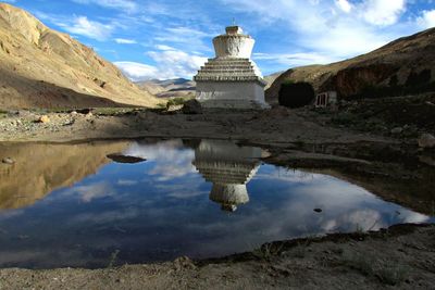 Stupa on field at ladakh against sky
