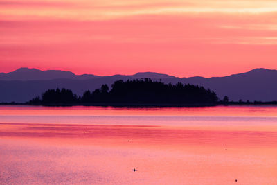 Scenic view of lake against romantic sky at sunset