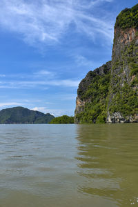 Scenic view of sea and mountains against sky