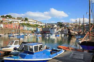 Boats moored at harbor in town