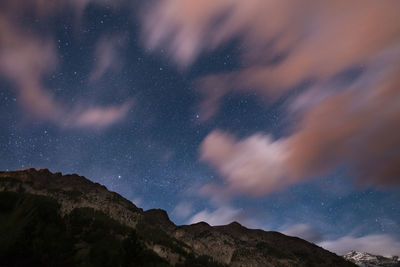 Scenic view of mountains against sky at night