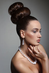 Close-up of beautiful fashion model against gray background