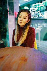 Portrait of a young woman with eyes closed