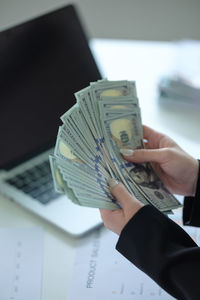 Cropped hand of businessman working on table