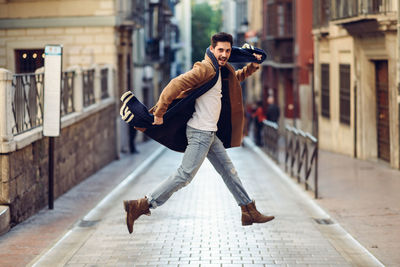 Portrait of fashionable man levitating in city