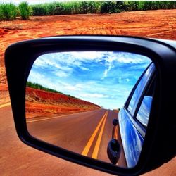 Close-up of side-view mirror of car