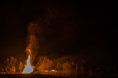 Panoramic view of illuminated building against sky at night