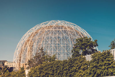 Low angle view of plants against building