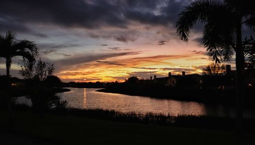 Scenic view of lake against orange sky