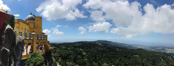 Panoramic view of buildings and mountains against sky