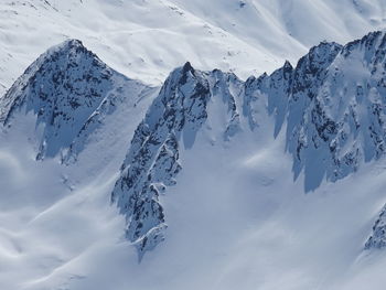 Aerial view of snowcapped mountains against sky