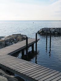 Pier on sea against sky