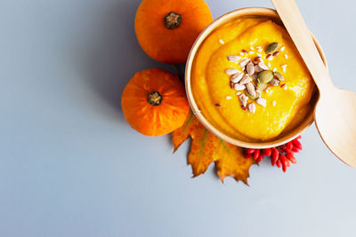 Thick vegan pumpkin cream soup with seeds in a disposable cup of craft paper. soup to go.